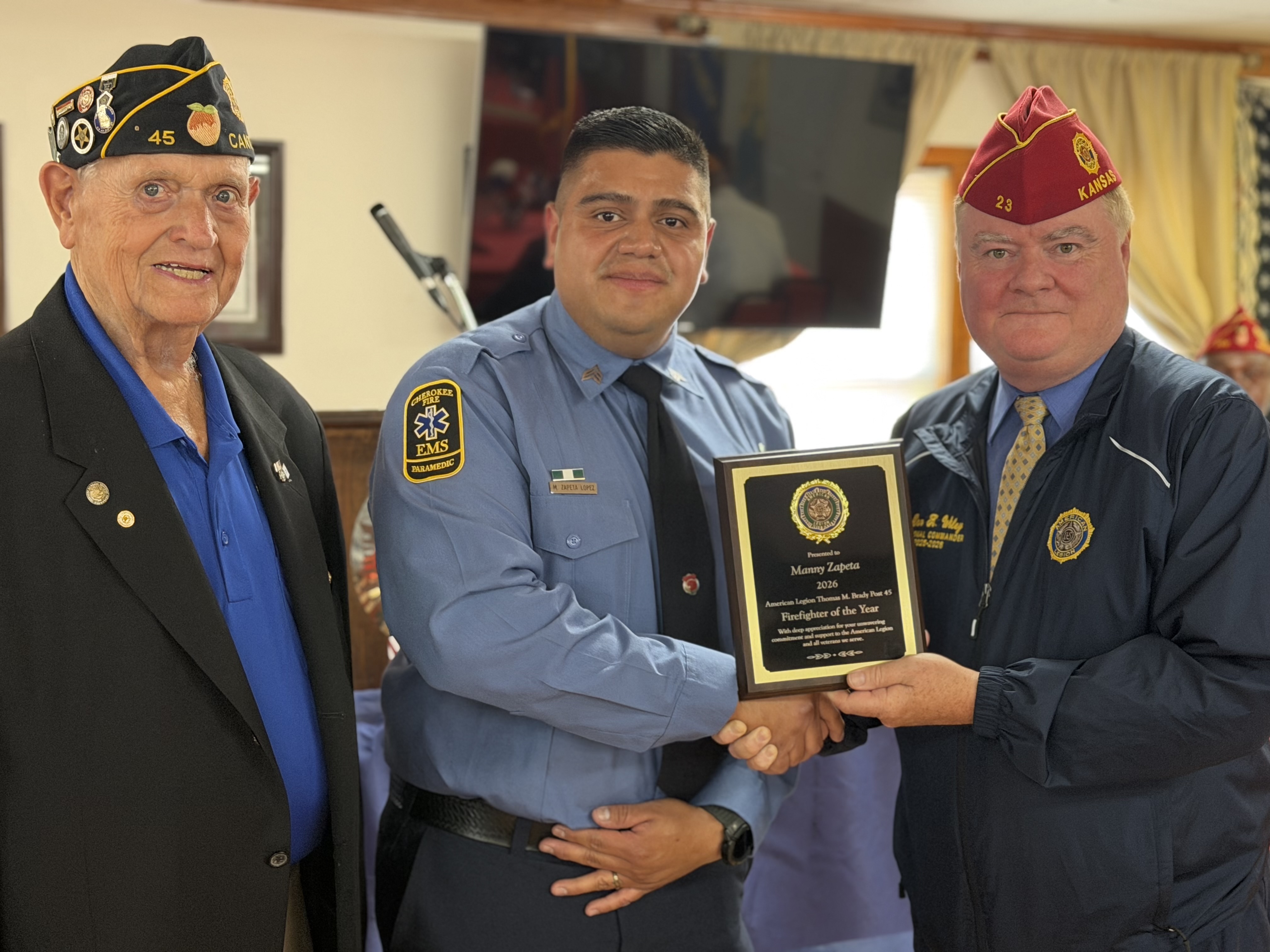 Sgt. Zapeta (center) being recognized by Post Commander Rollins (left) and National Commander Wiley (right).