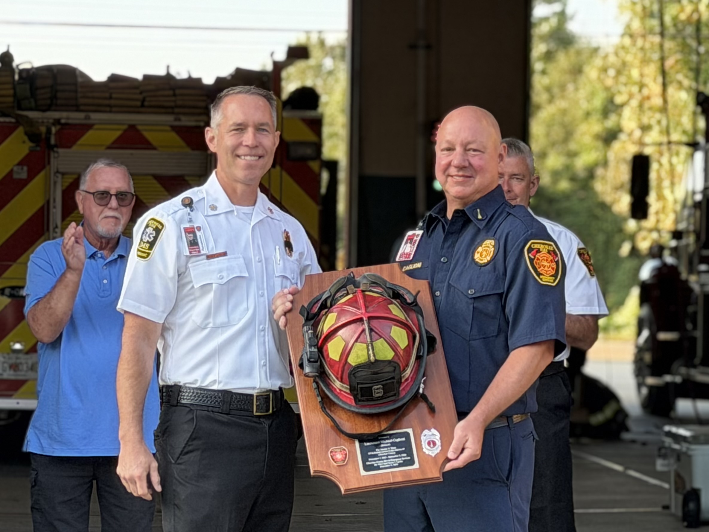 Lieutenant Caglioni is presented with a helmet plaque by Chief Lanier.